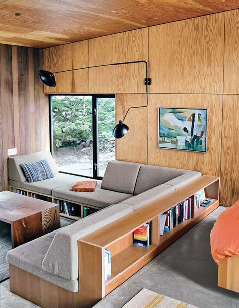 A built-in sectional outfitted with shelves turns this guest house in Sea Ranch, California, into the coziest reading nook of all.    Photo by Mark Mahaney.   This originally appeared in Modern Home Joins a Storied Site on the Pacific Ocean. Built In Sofa, Plywood Interior, Bohemian Living, Modern Cabin, Ideas For, Ideas Living, Design Living, Design Case, Small Living