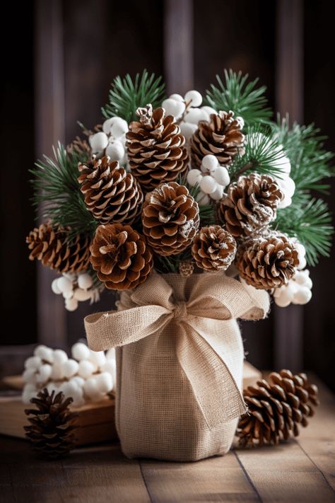 These rustic bunches look stellar with simple ceramic dishes; imagine a canvas of white, where your centerpiece paints the color. #Christmas #Holidays #HomeDecor Christmas Pine Cone Decorations, Simple Rustic Christmas Decor, Pine Cone Centerpiece, Burlap Ornaments, Diy Natal, Elf Decorations, Christmas Pine Cones, Burlap Decor, Mountain Lakes