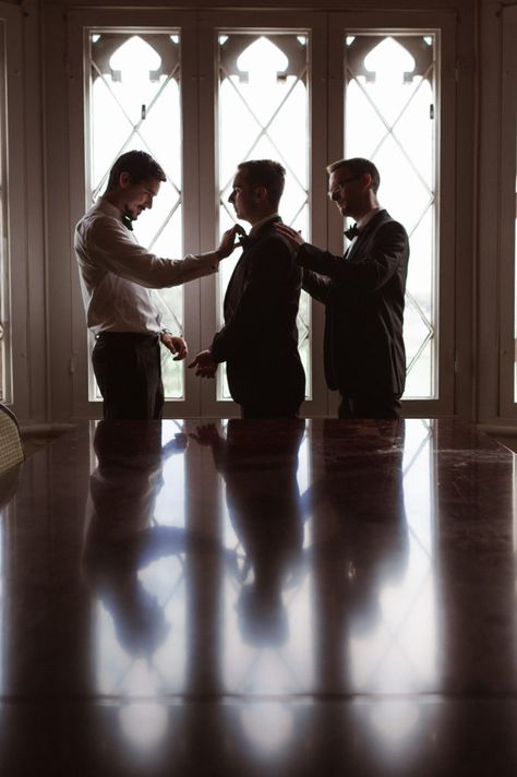 A groom prep photo with groomsmen getting ready Groomsmen Creative Shots, Men’s Wedding Photos, Groom Wedding Prep Photos, 2 Groomsmen Photos, Groomsmen Photoshoot Before Wedding, Grooms Photos Getting Ready, Groom Best Man Pictures, Wedding Details Photography Groom, 3 Groomsmen Photos