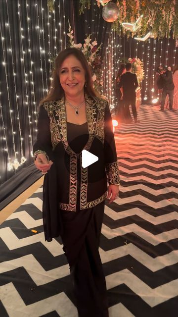 TheDressingRoom on Instagram: "Very beautiful @sangeeta_thukral5 in our black & gold drape set! This masterpiece is paired with a hand embroidered blazer in pure raw silk and our fusion wear draped saree gives the tradition and contemporary fashion. #thedressingroom_official #handcrafted #customised #festivewear #weddings #drapes #embroiderydesign #instafashion #instareels #fashiondesigner #designersuits #designeroutfit #instasong" Saree With Blazer, Black Pre-draped Saree With Zari Work, Elegant Style, Festive Black Pre-draped Saree In Traditional Drape, Black Glamorous Pre-draped Saree With Zari Work, Black Pre-draped Saree With Zari Weaving, Black Semi-stitched Pre-draped Saree With Zari Work, Gold Drapes, Saree Jackets, Drape Saree