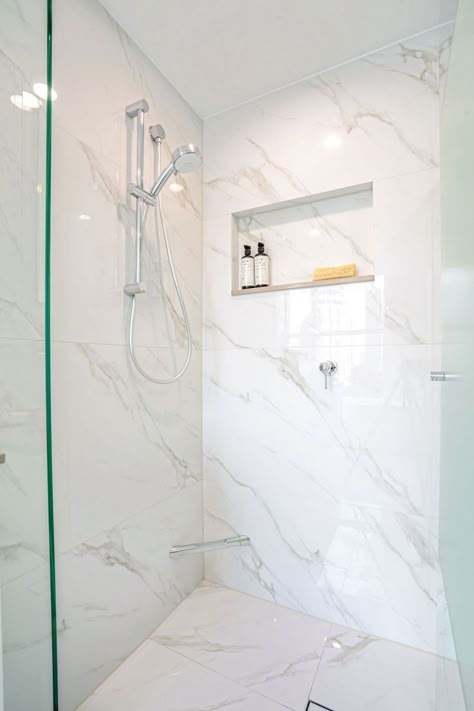 White Porcelain Tile Shower Walls, Groutless Tile Shower Ideas, Porcelain Marble Shower Walls, Large Marble Shower Tile, Carrera Tile Bathroom Shower Walls, Marble Ceramic Tile Bathroom, Vertical Marble Shower Tile, Minimal Grout Shower Tile, Porcelain Shower Wall Tile