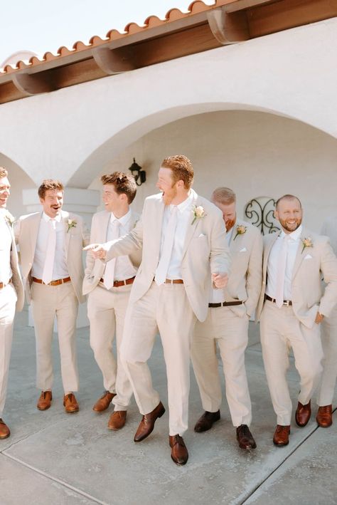 This groom is sporting a neutral tan suit with a navy tie for his summer wedding in Camarillo, California! Come see more groomsmen outfit trends, groom suit ideas, groomsmen style, california wedding venues, palm springs wedding venues, outdoor wedding venues in california, fall wedding inspiration, fall wedding ideas, and 2023 wedding trends. Book Kate for your luxury southern california wedding at kategarciaweddings.com! Tan Groomsmen Suits, Groomsmen Attire Beach Wedding, Groom Suit Ideas, Tan Groomsmen, Tan Suit Wedding, Wedding Venues In California, 2023 Wedding Trends, Palm Springs Wedding Venues, Groomsmen Outfit