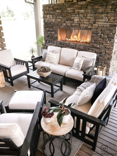 Luxurious outdoor living space with outdoor stone fireplace and beautiful black and white patio furniture. #outdoorspace #outdoorliving #patiodecor #patiofurniture #outdoorfireplace Black And White Outdoor Patio, White Outdoor Patio, Black And White Patio, White Patio Furniture, Black Patio Furniture, Outdoor Stone Fireplaces, Fireplace Patio, Fireplace Outdoor, White Patio