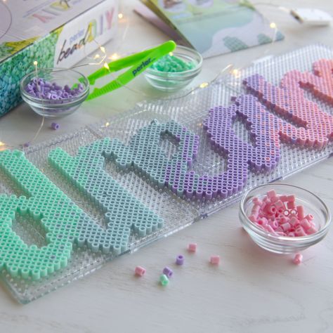 "Buy the Perler® Bead DIY Dream Light-Up Bead Art Kit at Michaels. Make a your own bedroom décor sign with this Perler bead DIY dream light-up bead art kit. Make a your own bedroom décor sign with this Perler bead DIY dream light-up bead art kit. Use the included Perler beads and pattern to spell out a pastel ombre, \"Dream,\" then wrap the letters in fairy lights, lean it up against the back of your desk or hang it on the wall. Turn on the lights to enjoy your cute DIY décor piece. Details: Inc Plastic Bead Crafts, Harry Potter Perler Beads, Melty Bead Designs, Pastel Ombre, Melty Bead Patterns, Pearl Beads Pattern, 3d Perler Bead, Bead Diy, Perler Bead Templates