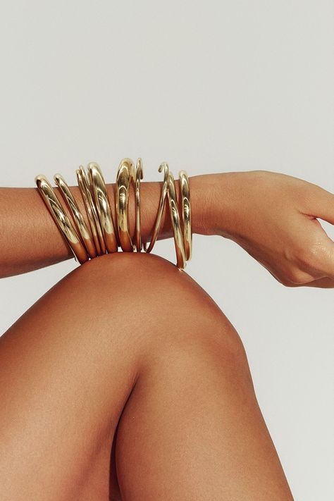 Filled with 18K gold, our Brazil-made tube cuff is the dynamic final touch – or the gleaming foundation of a sculptural bracelet stack. Mix in varying widths and finishes for the most impact. Jewelry Collection Handcrafted in Brazil 18K Gold Filled Thickness: 8.4mm Inner Diameter: 2.5" Opening: 1.25" Weight: 0.38 oz Waterproof Hypoallergenic Large Gold Jewelry, Gold Hoop Bracelet, Jewelry Stacks Gold, Jewelry Stack Aesthetic, Thick Gold Jewelry, Gold African Jewelry, Big Gold Jewelry, Stacked Gold Jewelry, Sculptural Bracelet