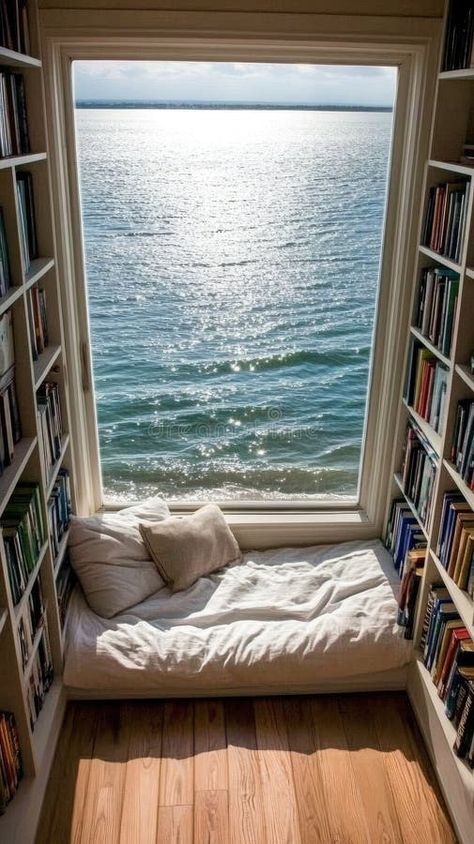 This serene reading nook features a window seat with soft cushions and a stunning view of the ocean, inviting relaxation stock photos Reading Room With Windows, Hammock Reading Nook, Beachy Library, Book Corner Aesthetic, Windowsill Seat, Window Sitting Ideas, Aesthetic Window Seat, Bay Window Reading Nook, Reading Corner Chair