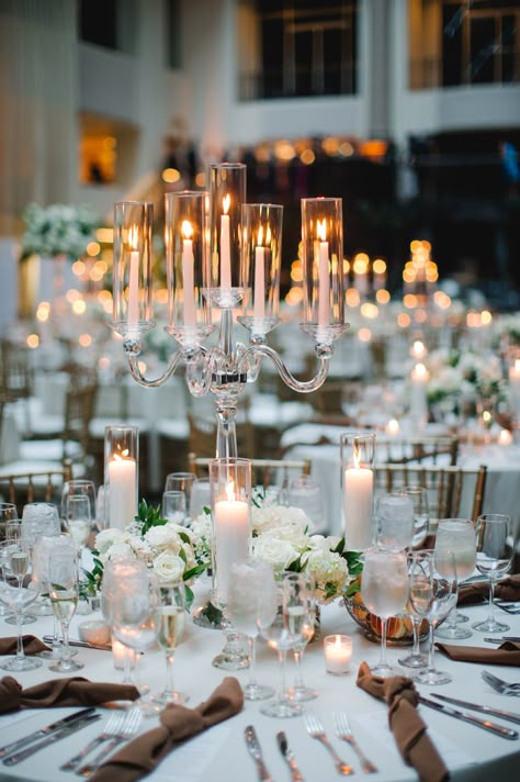 Classic arm crystal candelabra centerpiece with petite arrangements surrounding the base and more candlelight. PC: Asya Photography https://asyaphotography.com/ Chandelier Table Centerpiece, Large Candle Centerpieces Wedding, Candle Bar At Wedding, Candelabras Centerpieces, Candles As Centerpieces, Big Centerpieces, Chandelier Centerpiece Wedding, Candle Lit Wedding Tables, Candelabra Centerpieces