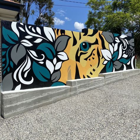 This external mural was painted to conceal a block wall and create interesting imagery as part of the entrance to the home. Simple botanical and tiger elements were used to create an interesting oversize artwork mural. Funny Murals, Interesting Wall Paint Ideas, Mural Wall Art Outdoor, Cool Wall Murals, Abstract Fence Mural, Exterior Murals Building, Street Art Graffiti Murals, Elephant Mural Painting, Tropical Mural Painting Outdoor