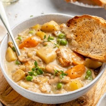 Hearty and delicious slow cooker white wine chicken stew filled with fresh herbs, veggies and plenty of protein. This creamy white wine chicken stew is easily gluten free and dairy free, and is truly a hug-in-a-bowl that's perfect for colder months! Serve with crackers, cornbread or homemade biscuits for the coziest dinner. #slowcooker #chicken #stew #healthydinner #glutenfree #comfortfood Chicken Stew Slow Cooker, Chicken White Wine, Slow Cook Chicken, Crockpot Chicken Stew, Cozy Soup Recipes, March Recipes, Stew Slow Cooker, Pregnancy Recipes, Cabin Food