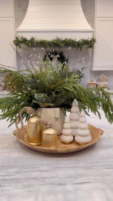 Ashley Savage | Creator | Atlanta, GA on Instagram: "🎄Christmas Kitchen Centerpiece🎄comment SHOP to get everything sent to your inbox! I know it is early, but these stems always sell out every year and they are currently on MAJOR sale, so I wanted to share!! I have been using these greenery stems for a couple years now and they are still my favorite! The light up branches are a fun touch and look beautiful at night. This Christmas centerpiece idea that would be so cute on your kitchen island for the holiday season! • • • #ltkholiday #ltkhome #christmasdecor #christmastree #christmascenterpiece #christmasideas #christmasdiy #christmasdecorating #christmastable #christmasgreenery #kitchencenterpiece #kitchenisland #kitchendecor #coffeetabledecor" Small Round Christmas Table Decor, Holiday Table Top Decor, Large Table Christmas Centerpiece, Christmas Mixing Bowl Decor, Christmas Dining Room Centerpiece Ideas, Ginger Jars Christmas Decor, Kitchen Island Centerpiece Ideas For Christmas, Christmas Decor In Glass Containers, Xmas Tray Decor Ideas