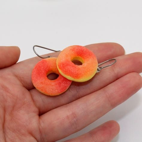 Super cute and realistic Gummy Peach Ring charms have been handmade by me from polymer clay. They have a realistic "sugar" texture. Charms measure about 1", total earring length about 1.5" each. Choose between gold plated or surgical steel (hypoallergenic) ear wires. *These are made to order, please expect a 2 week delay from time of purchase until time of shipment.**Every order comes with free gift packaging!Please contact me with any questions you may have and thanks for shopping FFD! Silly Earrings, Peach Ring, Marshmallow Candy, Candy Charms, Jewelry Kawaii, Candy Earrings, Weird Jewelry, Funny Earrings, Miniature Food Jewelry