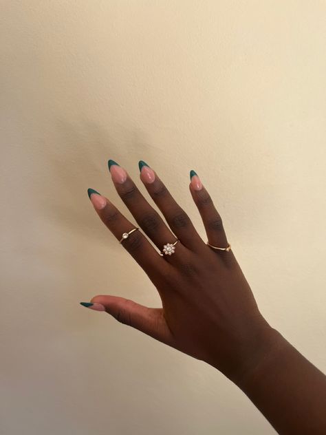 black girl hands and green French tips, almond shaped with golden rings Emerald Green French Tip Nails Almond, Dark Green Nails Almond, Forest Green French Tip Nails, Dark Green French Nails, Colour French Tips Nails, Emerald Green French Tip Nails, Dark Green French Tip, Dark Green French Tip Nails, Green French Tip Nails