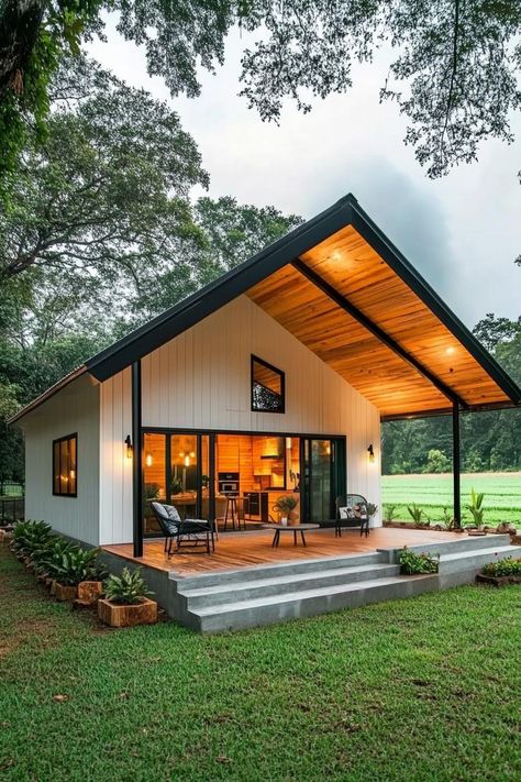 Cozy metal home with a wooden patio. Unravel the quirky charm and rock-solid perks of metal building homes, where modern design meets durable dinosaur-era construction vibes! Wooden Patio, Cabin Modern, Dinosaur Era, White Siding, Metal Building Home, Steel Frame House, Design Floor Plans, Wooden Patios, Home Design Floor Plans