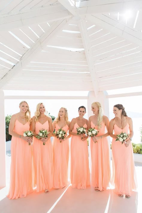 Bridal party in peach pleated bridesmaid dresses with white rose wedding bouquets Peach Color Bridesmaid Dresses, Peach Wedding Theme, Peach Dresses, Color Durazno, Color Of The Year 2024, Peach Bridesmaid Dresses, Peach Bridesmaid, Wedding Themes Spring, Coral Bridesmaid