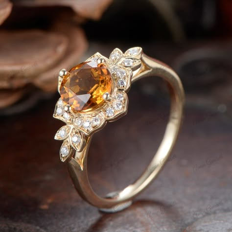 Similar item： https://www.etsy.com/listing/1763948733 This Unique Vintage Edwardian Citrine Ring is an exquisite piece of jewelry that beautifully combines historical elegance with modern sophistication. Crafted from 14K solid gold, the ring features a round-cut champagne citrine as its center stone, exuding a warm and captivating glow. The design includes intricate flower-de-luce motifs, characteristic of the Edwardian era, adding a touch of antique charm. As a solitaire ring, the focus remains Citrine Marquise Engagement Ring, Luxury Orange Diamond Engagement Ring, Engagement Rings Topaz Yellow, Yellow Rings Stones, Citrine Gold Ring, Orange 14k Gold Wedding Ring, Citrine Engagement Rings, Yellow Topaz Jewelry, Citrine Wedding Ring