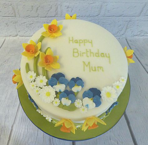 Spring flower birthday cake with daffodils and pansies. Spring Themed Birthday Cake, Daffodil Border Designs, Great Grandma's Daffodil Cake, Fondant Daffodils, Pottery Daffodils, Daffodil Cake, Fancy Daffodils, Farm Cakes, Flower Birthday Cake