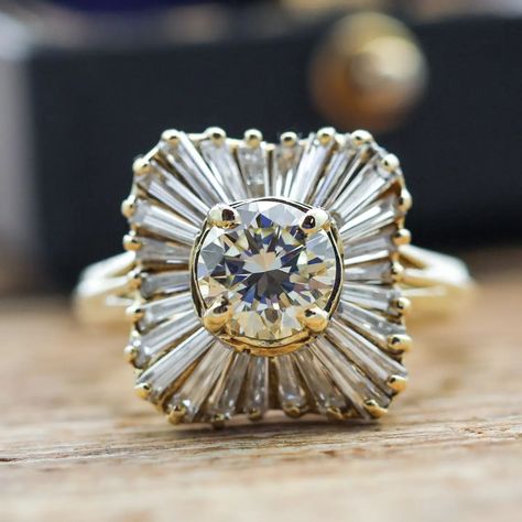 This ring centers a round brilliant cut diamond (1.05ct apx, N-O, VS2) set in 18k yellow gold with a halo of 26 tapered baguette cut diamonds (1.00ctw apx, K-L, VS) – sku: 130-08695 . . . . . . . #vintagejewelry #diamondring #engagementring #showmeyourrings #theknotrings Baguette Halo, Baguette Ring, Anniversary Gifts For Wife, Baguette Cut Diamond, Baguette Cut, Cluster Ring, Round Brilliant Cut Diamond, Moissanite Engagement, Round Brilliant Cut