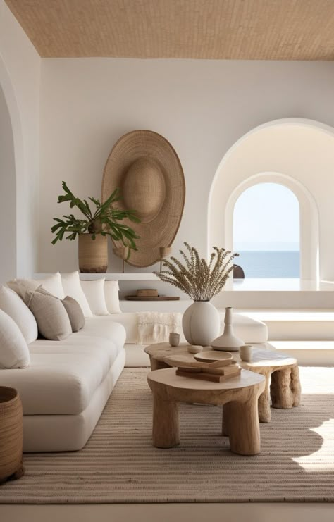 Step into serenity with this modern, Mediterranean-inspired living area. Revel in the raw materials, layered textures, and minimalist design. The wooden coffee table beautifully complements the pristine white couches, all set against a soothing beige backdrop. #SustainableDesign #MinimalistInteriors Modern Greek Style Interior Design, Mediterranean Interior Apartment, Medditeranean Style Interior, Mediterranean Vacation Home, Mediterranean Costal House, Mediterranean Living Room Design, Seaside Apartment Interior Design, Japandi Beach House, Minimalist Coastal Living Room