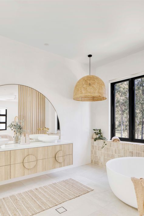 Breezy Mediterranean-inspired Queensland home, Casa Blanca Modern Mediterranean Laundry Room, Round Bathtub Ideas, Arch Mirror In Bathroom, House On Acreage, Pendant Over Bathtub, Timber Vanity Bathroom, Bathroom With Closet, Mediterranean House Interior Design, Coastal Boho Bathroom