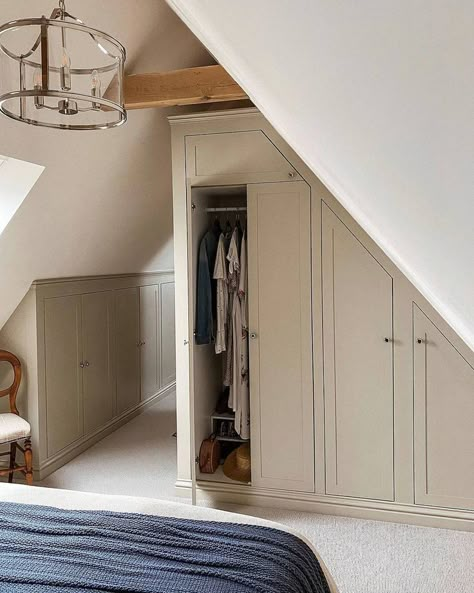 Another way of optimizing your room with slanted ceilings is to have built-in storage surrounding its perimeter–like this beige feature. Image credit: INSTAGRAM @rosecottagerevival Bedrooms With Slanted Ceilings, Small Attic Bedroom Designs, Attic Bedroom Closets, Slanted Ceiling Bedroom, Attic Master Suite, Small Attic Bedroom, Small Attic Room, Bedroom Design Diy, Slanted Walls