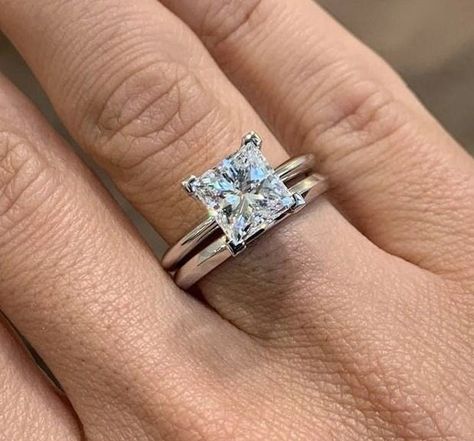 Celebrate your love and commitment with this exquisite Princess Cut Moissanite Wedding Ring Bridal Set. Expertly handcrafted, this set includes an engagement ring and a matching wedding band, designed to complement each other perfectly. The engagement ring features a mesmerizing princess cut Moissanite stone, known for its exceptional brilliance and fire. It is delicately set in a lustrous white gold band, accentuated by smaller, shimmering diamonds along the band. The matching wedding band is c Princess Cut Engagement Ring With Wedding Band, Platinum Princess Cut Engagement Ring, Silver Princess Cut Engagement Ring, Silver Square Engagement Rings, Engagement Rings Plain Band, Princess Cut Engagement Ring With Band, Simple Engagement Rings Princess Cut, Princess Cut Engagement Ring Set, Solitaire Wedding Ring Set