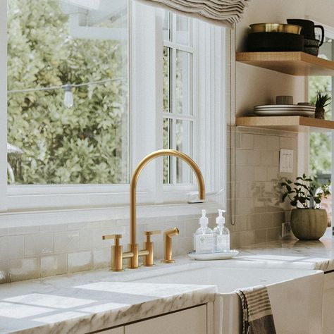 Brass Farmhouse Faucet, Antique Brass Faucet Kitchen, Bridge Kitchen Faucet With Sprayer, Black Sink With Gold Faucet, Kitchen Faucets 2024, Gold Fixtures Kitchen, Gold Kitchen Fixtures, Brass Kitchen Faucet Pull Down, Brushed Brass Kitchen Faucet