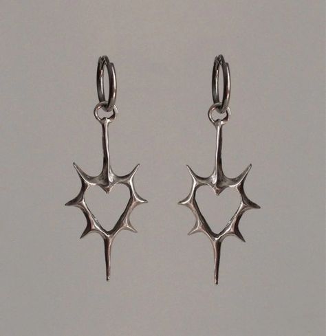 Front view of the heart Stellar Edge Earrings in a gray background Alt Earrings Aesthetic, Silver Jewelry Women, Gothic Earrings Aesthetic, Grunge Piercings Ear, Silver Gothic Jewelry, Home Made Earrings Ideas, Silver Charm Earrings, Cool Ear Piercings Punk, Cool Silver Jewelry