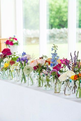 I love this! All different colors mixed together for a country wildflower feel. So laid back and easy. Cocktail Flowers, Table Floral Decorations, Flower Centrepieces, Vases With Flowers, Vail Wedding, Deco Champetre, Table Flower, בר מצווה, Planning Inspiration