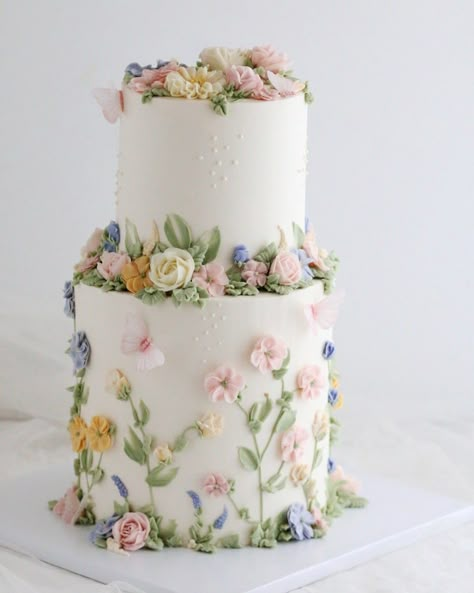 Buttercream wildflowers and roses two-tier cake. White Cake With Wildflowers, Flower Cake 2 Tier, Bridal Shower Cake Flowers, Spring Pastel Wedding Cake, 2 Tier Floral Cake Birthday, Pastel Wedding Cake Flowers, Wedding Cakes With Buttercream Flowers, Buttercream Fairy Cake, Single Tier Cake Birthday