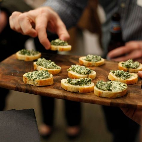 someone grabbing an appetizer off of a serving platter at a party. Roasted Whole Eggplant, Party Food Hacks, Room Temperature Appetizers, Cheese Ball Dip, Busy Mom Recipes, Creamy Spinach Dip, Greek Appetizers, Recipe Appetizers, Wedding Cocktail Hour