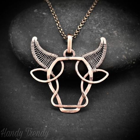 Handy Trendy on Instagram: "****sold****This Taurus pendant is made of copper wire with zig-zag weaving in horns. Oxidized and polished for an antique look.
This is something different animal design I ever made and this bull pendant is more like a Celtic-style animal. I didn't use any stone in this design and kept it simple so it's a unisex pendant and anyone can wear it.

Check out this Taurus pendant in my Etsy shop.

Shop link in bio.📲
.
.
.
#wirewrap #wirewrapping #wirewrapped #wirewrappedjewelry #crystallover #oneofakind
#oneofakindjewelry #artistoninstagram #uniquejewelry #gemstonejewelry #crystaladdict #talisman #healingjewelry #crystalhealing #alternativehealing #reikihealing #reikienergy #empathic #empathsofinstagram #empathprotection #wearableart #uniquenecklace #crystalhealing Wire Wrapped Frog Pendant, Copper Wire Crafts Diy, Bull Pendant, Taurus Pendant, Copper Wire Crafts, Art Fil, Taurus Bull, Wire Wrap Jewelry Designs, Handmade Birthday Gifts