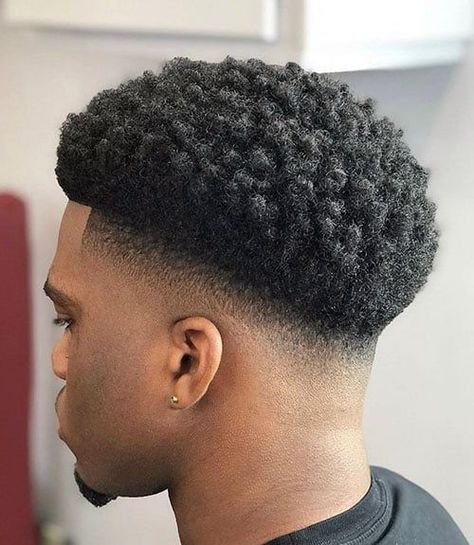 Drop Fade Afro. This textured afro fade is a stylish, versatile and trendy hairstyle for black men wanting a modern variation on the classic look. A fresh haircut that pairs a sleek, cool fade on the sides and back with longer, afro-textured hair on top will elevate your aesthetic, creating a charming look that stands out. Hair Cuts Black Man, Mid Taper Fade Haircut Black Men, Taper Fade Afro, Afro Hair Fade, Afro Fade Haircut, Black Man Haircut Fade, Temp Fade Haircut, Waves Hairstyle Men, Taper Fade Short Hair