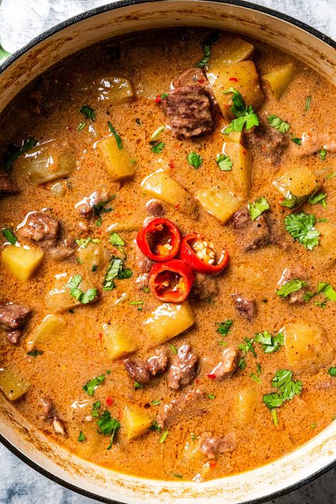 This beef Massaman curry made from scratch is pure comfort food. The rich, fragrant Thai curry is slow-cooked with tender beef chunks, potatoes, smoky chilies, and creamy coconut milk until the meat is tender and the sauce is flavorful. #massaman #thai #curry Beef And Potato Curry, Thai Massaman Curry Recipe, Massaman Beef Curry, Massaman Curry Chicken, West Indian Curry, Beef Curry Recipes, Lamb Massaman Curry, Coconut Beef Curry, Massaman Curry Recipe