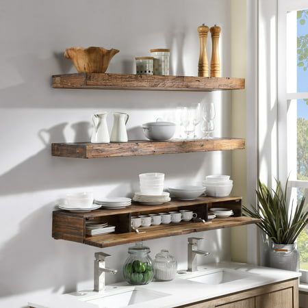 Stylize your kitchen with these decorative but functional floating wall shelf. Deep enough to showcase ceramic ware, the thick distressed wood design makes this piece both visually substantial and structurally rigid. A concealed internal compartment can store teas, tools, and more. Installation is very easy, and includes a french cleat. Made from quality Acacia hardwood, this unit will make a great highlight piece for your kitchen. Color: Brown. Lights Over Floating Shelves Kitchen, Reclaimed Wood Kitchen Shelves, Open Shelving In The Kitchen Wall Shelves, Rustic Floating Shelves Kitchen, Wooden Floating Shelves Kitchen, Floating Live Edge Shelves, Decorating With Shelves, Floating Shelves In Kitchen, Kitchen Floating Shelves Decor