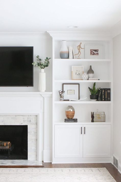 White open bookcases next to fireplace, marble subway tile, shelf styling, how to style shelves, tv mounted above fireplace, neutral room, neutral rug, Shelves On Fireplace Hearth, Classic Grey Living Room, Hamptons Fireplace, Decorating Built In Shelves, Bookcase Fireplace, Coastal Styling, Fireplace Bedroom, White Built Ins, Built In Around Fireplace