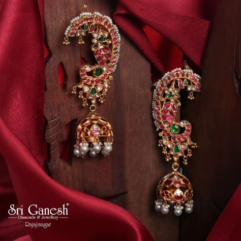 Exquisite traditional jhumka earrings adorned with vibrant rubies, emeralds, and pearls, beautifully crafted to enhance your ethnic charm. Timeless Treasures 🪔 Shop the Collection: 📍 : 335 1st 'N' Block, Near Vidya Vardhaka School, Rajajinagar, Bangalore-560010 📱 Call/Whatsapp:   9845479000 / 9845212200/  9606777598 Shop online at  www.sriganesh.live Email: info@sriganesh.com #SriGaneshDiamondsAndJewellery #Rajajinagar #AssuredGifts #FineJewellery #Gold #Diamonds #Platinum #polkijewel... Jumkas Gold Traditional, Ear Cuffs Gold Indian, Kundan Earrings Jhumkas, Earrings Gold Indian, Ruby Earrings Gold, Deity Jewellery, Big Earrings Gold, Traditional Jhumka, Jhumkas Earrings