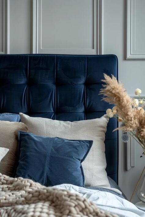 Transform your bedroom with stunning navy blue headboard ideas that add a stylish, fresh vibe to your space. From bold and contemporary looks to elegant, classic styles, discover different ways to incorporate this striking color into your decor. Whether you're interested in a royal navy velvet finish or modern shapes, we’ve got you covered! Create a relaxing retreat that showcases your personality while enhancing warmth and comfort. Take inspiration from these creative bedroom setups and kiss dull interiors goodbye. Midnight Blue Headboard, Bedroom With Blue Bed Frame, Navy Velvet Headboard Bedroom, Navy Headboard Bedroom Decorating Ideas, Royal Blue Headboard, Bedroom Blue Headboard, Navy Blue Headboard Bedroom Ideas, Blue Velvet Bedding, Blue Headboard Bedroom Ideas