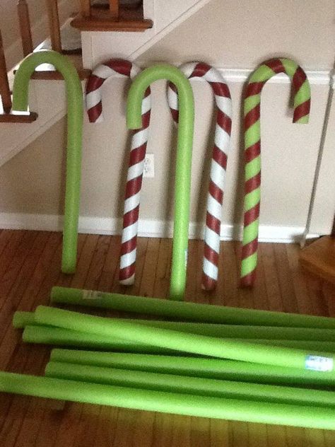 pool noodle candy canes  made with pool noodles & wire hangers. make straight wire hanger slide into pool noodle & bend to shape, paint. Slide Into Pool, Noodle Candy Canes, Pool Noodle Candy, Noodle Candy, Paint Christmas, Grinch Decorations, Grinch Christmas Party, Halloween Decor Diy, Whoville Christmas