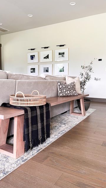 Elisabeth Yeary | organic modern | on Instagram: "Reasons I love a bench over the traditional console table behind the couch: ▫️provides additional seating ▫️it’s perfect for open concept homes ▫️the low profile makes your space feel more open. ▫️gives your guests somewhere to leave their bag . . . . . #naturaldecor #ltkhome #ltkstyletip #neutraldecor #behindthesofa #homestyling #openconcept #benchstyling" Console Table Bench, Bench Seating Family Room, Couch Placement Ideas Open Concept, Console Table Sectional, Wooden Bench Behind Sofa, Wood Bench Behind Sofa, Back Of Couch Bench, Behind The Couch Bench Decor, Behind Sofa Bench