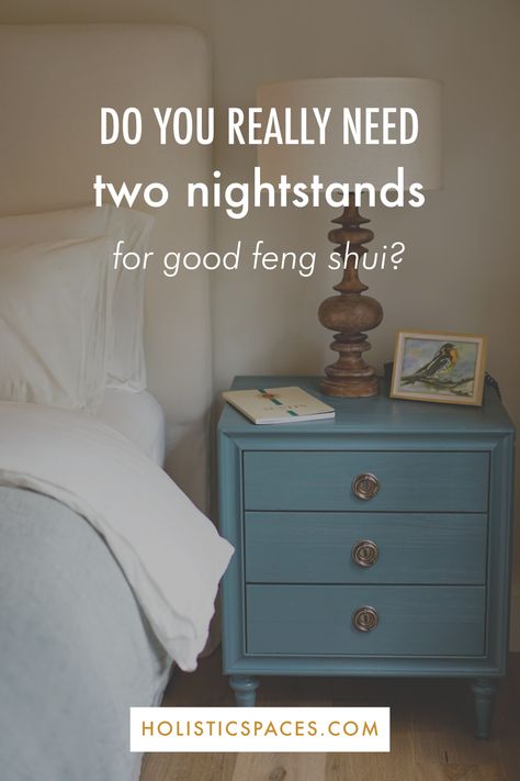 Photo of blue nightstand with lamp, picture, and journal next to bed. Text: do you really need two nightstands for good feng shui? holisticspaces.com Feng Shui Bedroom Nightstand, Bedroom One Nightstand Ideas, Matching Nightstands Bedroom, Only One Nightstand In Bedroom, One Bedside Table In Bedroom, Single Nightstand Bedroom Layout, Bedroom Layout With One Nightstand, Feng Shui Nightstand, Bedrooms With One Nightstand