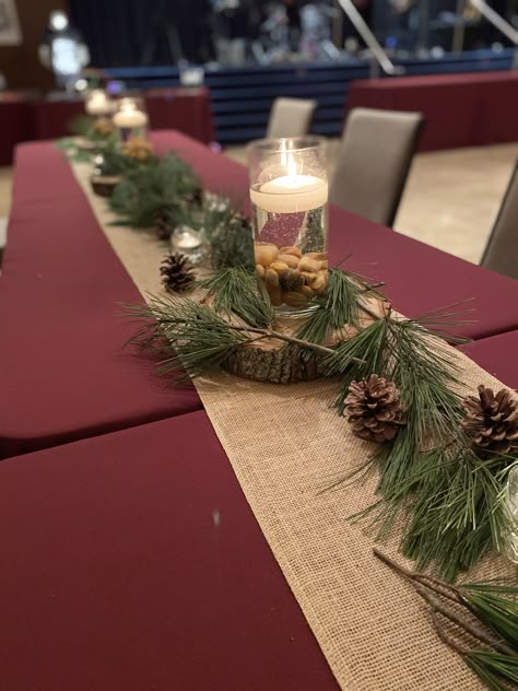 Wilderness Table Decorations, Burgundy And Pine Cone Wedding, Pinecone Table Decorations, Pine Tree Table Decorations, Nature Wedding Centerpieces Simple, Rustic Winter Birthday Party, Pine Table Runner, Wedding Centerpieces With Pinecones, Table Decor With Pine Cones