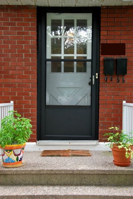 So remember this post back in May when I threw around some options for paint colours for our front door? And how I was trying to make it work with our uber-ugly brown screen door? The screen door that didn’t match with our house numbers, mailboxes, or shutters? Well, I couldn’t make a decision about … … Continue reading → Painting Garage Door, Painted Storm Door, Porch Building, Black Screen Door, Painted Screen Doors, Brown Screen, Metal Screen Doors, Front Door With Screen, House Brick