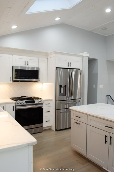 white kitchen cabinets, vaulted shiplap ceiling with skylight, gray island, white gray marble countertop Small Kitchen Skylight Ideas, Vaulted Kitchen Cabinets, Split Level House Kitchen, Vaulted Shiplap Ceiling, Shiplap Kitchen Wall, Kitchen Wall Removal, Kitchen With Vaulted Ceiling, Kitchen Countertops And Backsplash, Kitchen Skylight