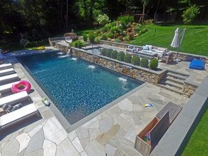 New Swimming Pool Construction Rectangular Pool With Slide, Pool With Retaining Wall Sloped Backyard, Pools With Retaining Walls Sloped Backyard, Pool Retaining Wall, Construction Portfolio, Underground Pool, Luxury Pools Backyard, Backyard Upgrades, Simple Pool