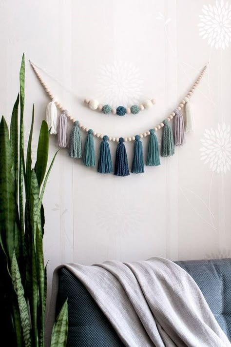 Blue Wall hanging over the bed wall decor.#Creativ #Dies # #WoodWorking #DIY #Crafts Hanging Tassels Decor, Macrame Bead Garland, Wood Hanging Decor Wooden Signs, Nursery Tassel Garland, Wood Bead And Tassel Garland, Over The Bed Garland, Wood Garland Decor Ideas, Boho Nautical Nursery, Diy Boy Room Decor