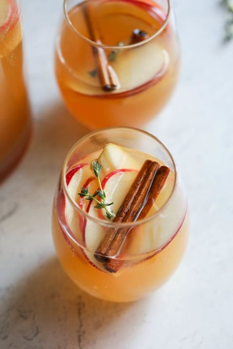 Looking for the best cocktail recipe for fall? Our Apple Cider Sangria recipe is just the thing to sip on when apple-picking season is upon us. We love to serve this quick, make-ahead, no-sugar-added sangria recipe at all the fall and winter parties and holidays. It's made simply with fresh in-season fruits, apple cider, kombucha or ginger beer, and warming spices. Sangria Mocktail, Apple Cider Sangria Recipe, Holiday Champagne, Easy Sangria Recipes, Sangria Cocktail, Apple Cider Sangria, Cider Sangria, Real Food Dietitians, Fall Cocktails Recipes