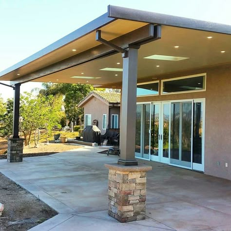 Insulated aluminum patio cover with skylights, LED recessed lighting and stone wrapped columns #aluminumpatiocover #stonecolumns #southerncalifornia #solidpatiocovers #alumawood #skylightsinpatiocovers Steel Patio Cover, Metal Covered Patio Ideas, Patio With Skylight, Patio Cover With Skylights, Patio Columns Ideas, Covered Patio With Skylights, Partially Enclosed Patio Ideas, Aluminum Patio Covers Attached To House, Alumawood Patio Covers Ideas