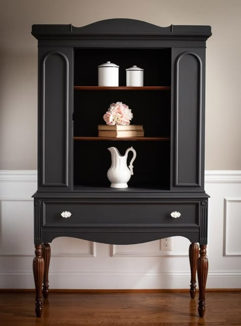 "I just love how this vintage china hutch turned out. Painted in a custom mix of General Finishes Lamp Black and Queenstown Gray, a gorgeous color was made. I’ll call it Graphite Gray! The legs and shelves were stripped to bare wood and stained in walnut gel stain. New hardware complete the look. I just love her new makeover. Definitely a one of a kind piece" - Vintage Actually Decor Painted Dresser Makeover, Armoire Makeover Black, Moody Furniture Makeover, Small Hutch Makeover, Modern Hutch Makeover, Black Hutch Makeover, Black Antique Furniture, Antique Cabinet Makeover, Refurbished Hutch Ideas