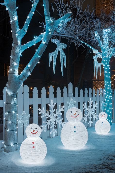 Ice-blue LED lights, frosted icicle ornaments, glowing snowmen, and frosted crystal snowflakes in a snowy outdoor setting. Christmas Decor Ideas Outdoor Walkway, Jack Frost Decorations, Winter Wonderland Outdoor Decorations, Elegant Outdoor Christmas Decorations, Christmas Fence Decorations Outdoor, Outdoor Christmas Decorations Ideas, Elegant Wreaths, Oversized Ornaments, Outdoor Christmas Decoration Ideas