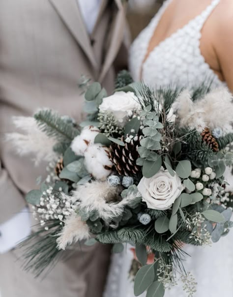 Dark Green Winter Wedding Theme, Winter Theme Wedding Bouquet, Winter Wedding Flowers Bouquets White Pine Cones, Winter Floral Arrangements Wedding Bridal Bouquets, Winter Theme Wedding Centerpieces, Wedding Bouquets Bride Winter, Wedding Bouquets December, Grand Wedding Reception, Winter Wedding Christmas Tree Decor